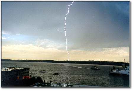 lightning striking seattle - behind the argosy ferry from kirkland wa in 8-3-99